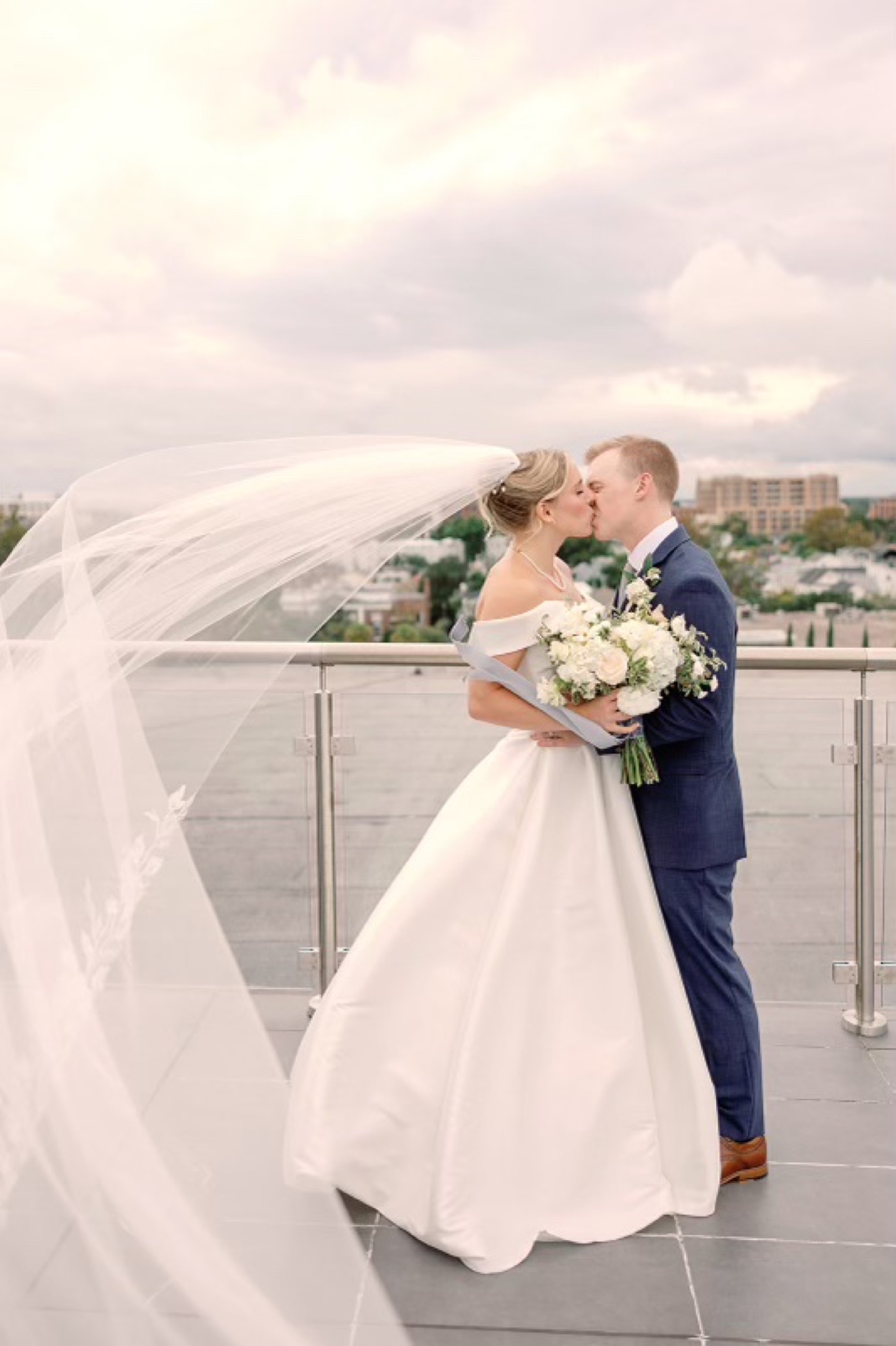 Bride and groom kissing at the altar
