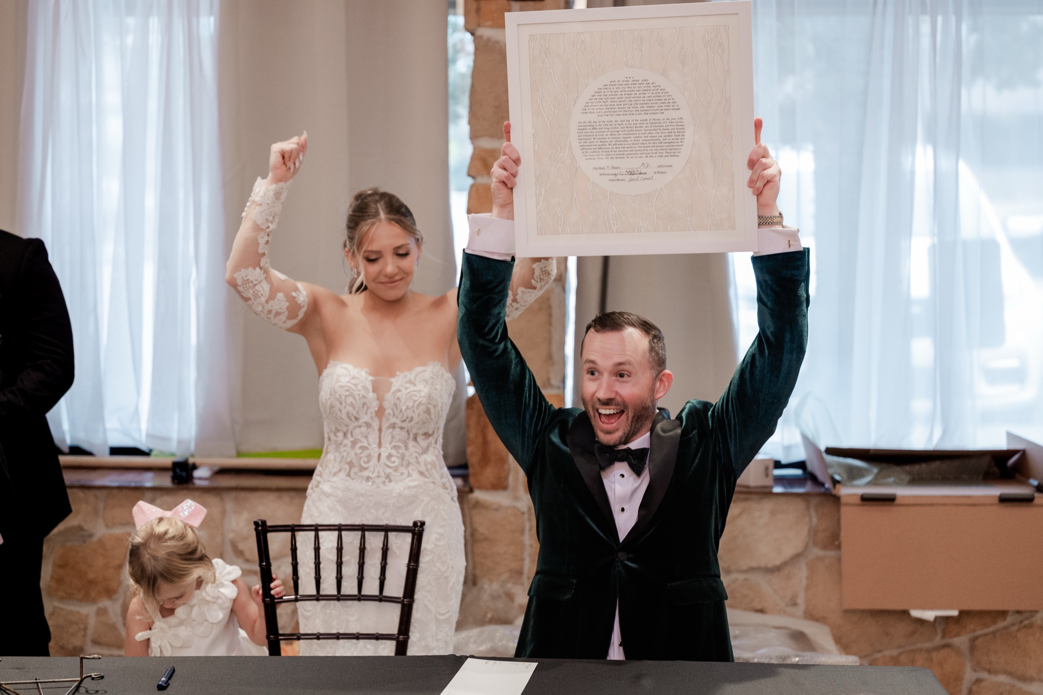 Bride and groom celebrating signing the ketuba