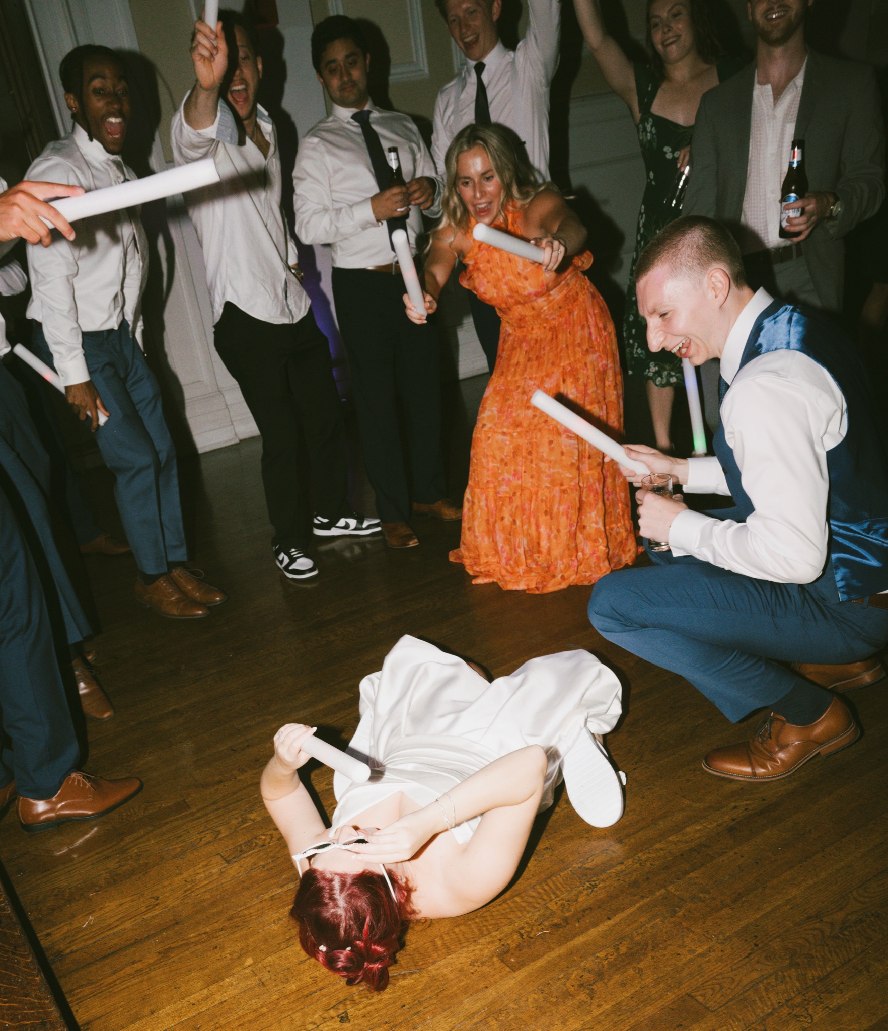 Bride singing into a glowstick on the dance floor