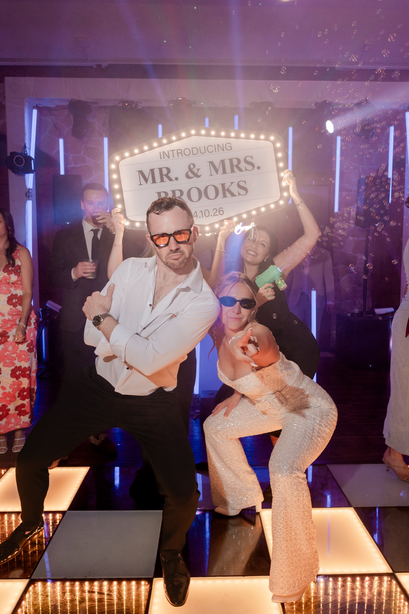 Bride and groom with Mr & Mrs Brooks bottle service sign