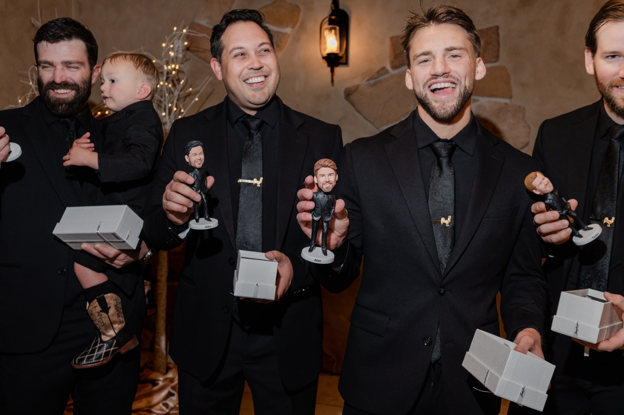 Groomsmen holding a bobblehead gift of the groom