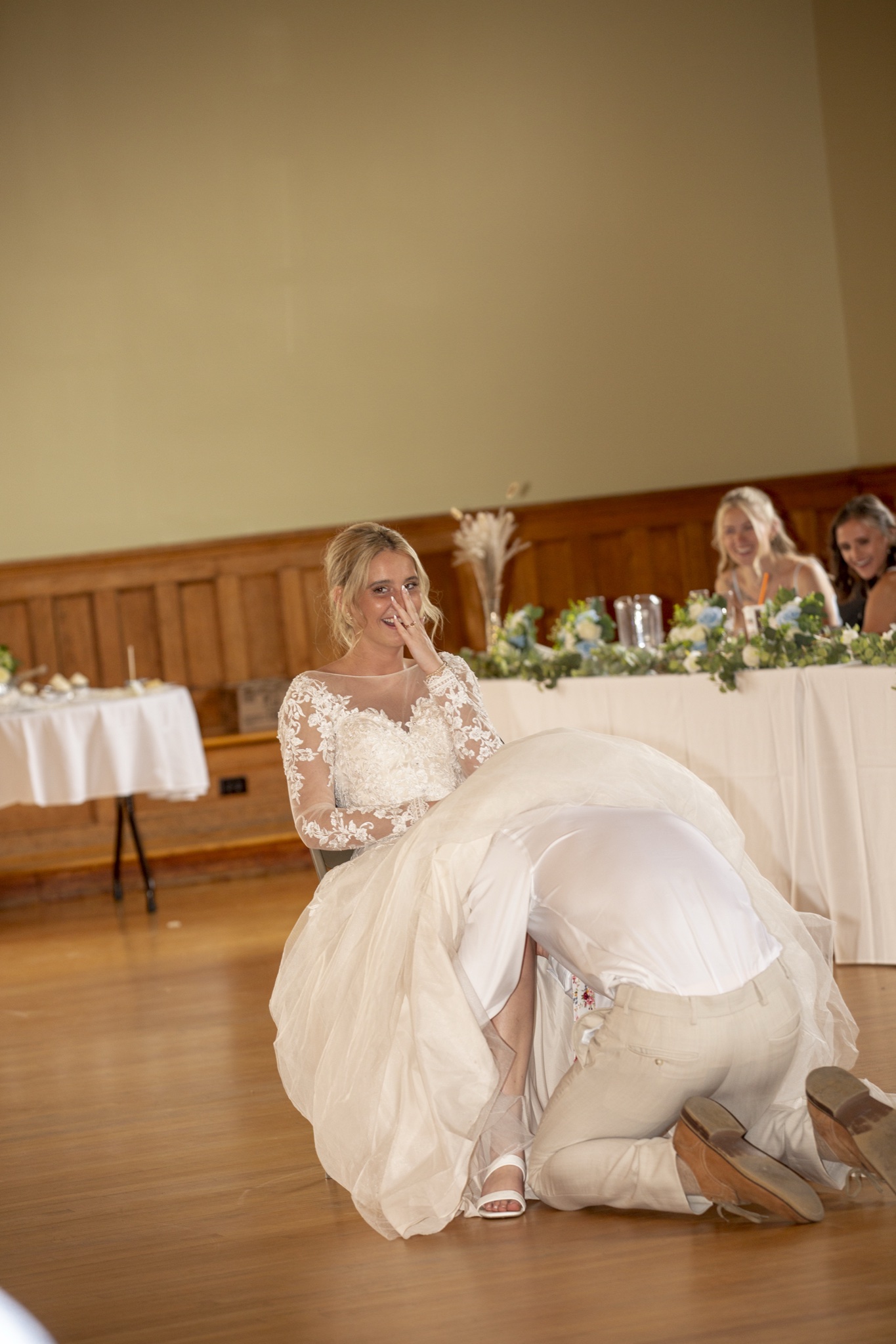Groom sneaking under the bride's dress — very funny moment